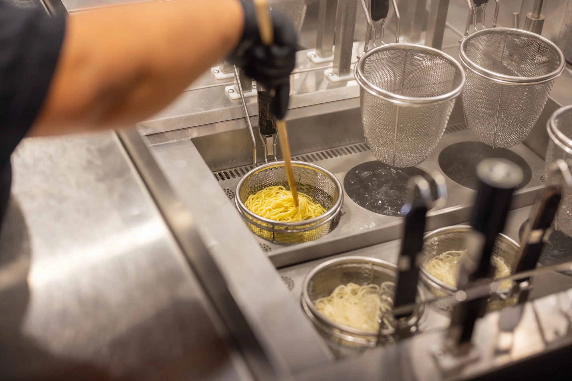 Tatsu Ramen chef preparing fresh noodles in the kitchen